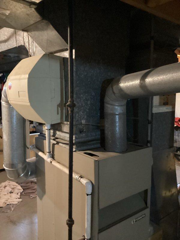 Responded to service call for air conditioner that would not start. Conducted comprehensive system evaluation of existing HVAC installation in basement utility area. Assessed furnace, ductwork connections, and associated components including water heater and humidifier systems. Documented current equipment configuration with photographic evidence showing galvanized metal ductwork, PVC piping connections, and overall system layout. Prepared full system and single component replacement estimate options for customer consideration.