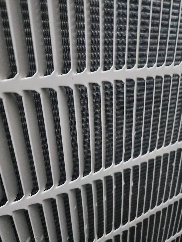 Completed routine maintenance on 3-5 ton air conditioning system including inspection of evaporator coil assembly and compressor unit. Photographically documented clean condenser fins, properly functioning compressor with refrigerant lines, and drain pan condition showing normal condensate staining, confirming system is operating within manufacturer specifications.