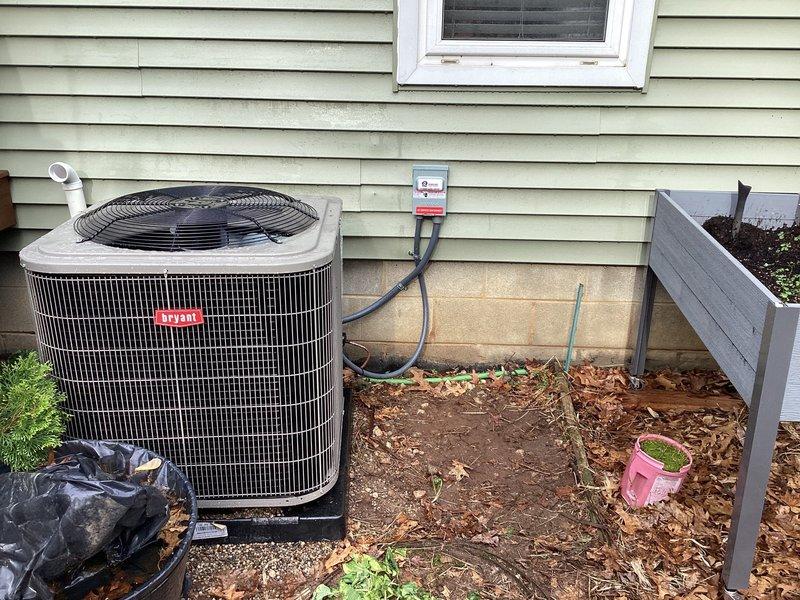 Completed installation of new Bryant air conditioning system including outdoor condensing unit and indoor evaporator coil with associated refrigerant lines, electrical connections, and condensate drainage. Installed whole-home humidifier integrated with existing ductwork, verified proper electrical disconnect at exterior unit, secured all refrigerant piping and electrical conduit per code requirements, tested system operation and confirmed optimal performance of both cooling and humidification components.