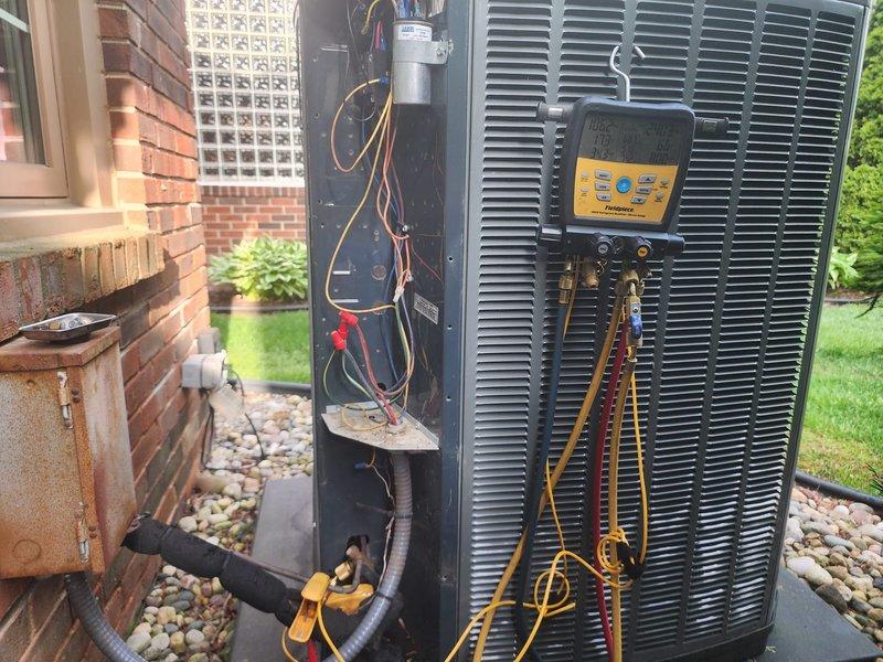 Completed scheduled air conditioning maintenance on residential split system. Performed system diagnostics using manifold gauges to check refrigerant pressures and verify proper operation. Inspected outdoor condenser unit, noting age-related weathering and mineral deposits on coil fins. All components operating within normal parameters at time of service.