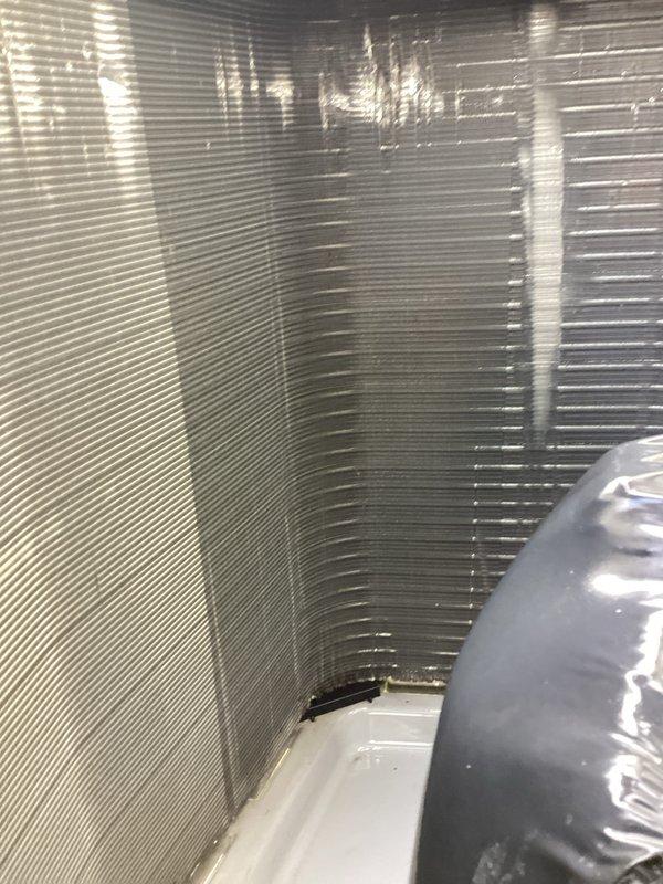 Responded to service call regarding blower not pushing air adequately in AC system. Upon inspection, discovered significant deterioration of insulation material on the evaporator coil assembly, with multiple tears and compromised sections exposing underlying surfaces. Examined air handler unit interior, noting heat exchanger coils and drain pan assembly appeared functional. Verified copper refrigerant lines and electrical connections were intact. Performed complete maintenance service on system, including inspection of all accessible components. System operation confirmed following service work.