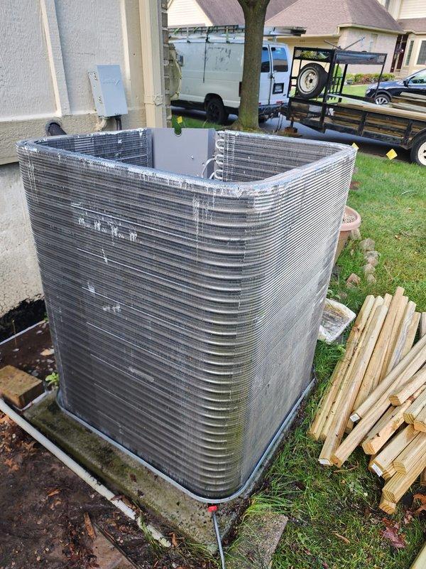 Performed comprehensive cooling system maintenance on residential air conditioning unit. Completed full system inspection including examination of outdoor condenser unit with curved aluminum fin design, verified compressor operation and refrigerant line connections, and documented equipment condition through detailed photography. System confirmed operational with no issues identified during tune-up service.