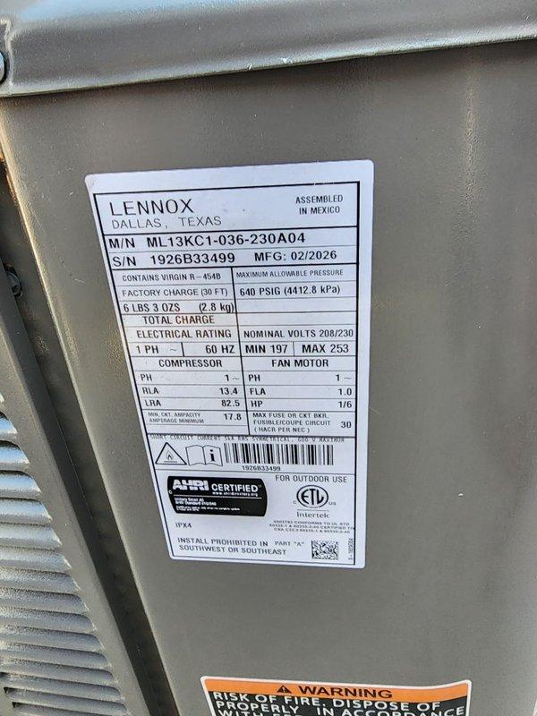 Completed installation of Lennox ML13KC1-036-230A04 downflow air conditioning system for mobile home application. Unit installed on concrete pad with proper electrical disconnect, refrigerant lines charged with R-454B per factory specifications, and system tested for proper operation upon completion.