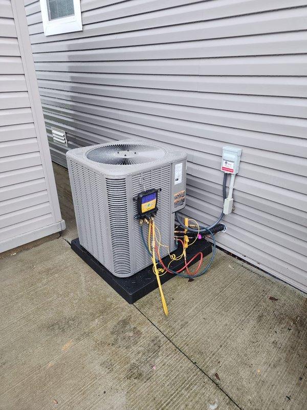 Completed installation of Lennox ML13KC1-036-230A04 downflow air conditioning system for mobile home application. Unit installed on concrete pad with proper electrical disconnect, refrigerant lines charged with R-454B per factory specifications, and system tested for proper operation upon completion.
