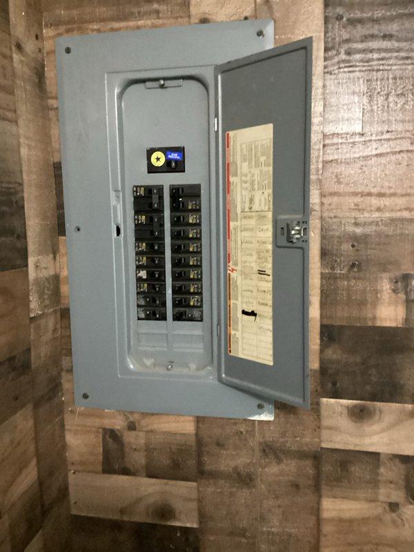 Conducted on-site evaluation for new air conditioning system installation at residence currently without cooling equipment. Assessed electrical service panel in basement utility area to verify adequate capacity and circuit availability for new AC unit installation. Inspected existing ductwork and wall-mounted return air register to determine compatibility with proposed system. Documented electrical infrastructure and interior HVAC components through photography to develop comprehensive installation estimate for customer's preferred equipment location.