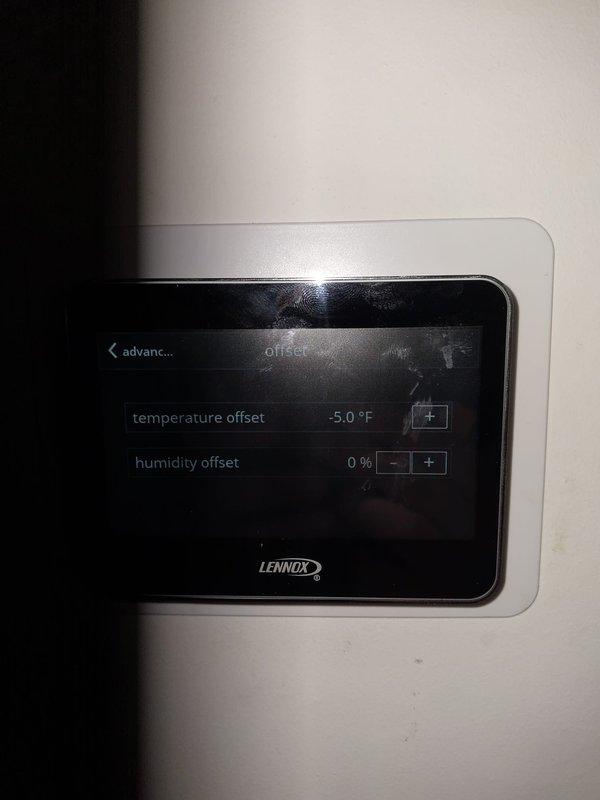 Installed Air Scrubber 10000 12-2 indoor air quality system to existing HVAC equipment. Verified proper operation and adjusted thermostat temperature offset settings to -5.0°F to ensure accurate temperature control with new IAQ equipment installed.
