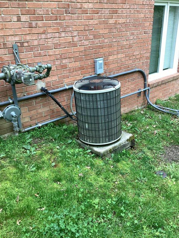 Conducted comprehensive site assessment for replacement of two complete HVAC systems including furnace and air conditioning units. Evaluated existing outdoor condenser unit installation on concrete pad with refrigerant line penetrations through exterior brick wall, noting proximity to natural gas meter assembly and electrical connections. Inspected attic installation access point, documenting PVC condensate drain line configuration with evidence of rust staining at mounting connections and assessed insulation conditions around existing ductwork and penetrations. Provided detailed estimate for dual system replacement including equipment specifications, installation requirements, and necessary modifications to existing infrastructure.