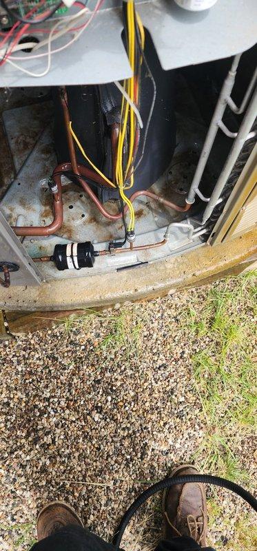 Completed comprehensive AC tune-up on 10-year-old air conditioning system. Performed standard maintenance inspection including examination of condenser unit, refrigerant lines, electrical connections, and compressor components. Documented existing base plate corrosion and overall unit condition with photos; system operational with no immediate service issues identified at time of visit.