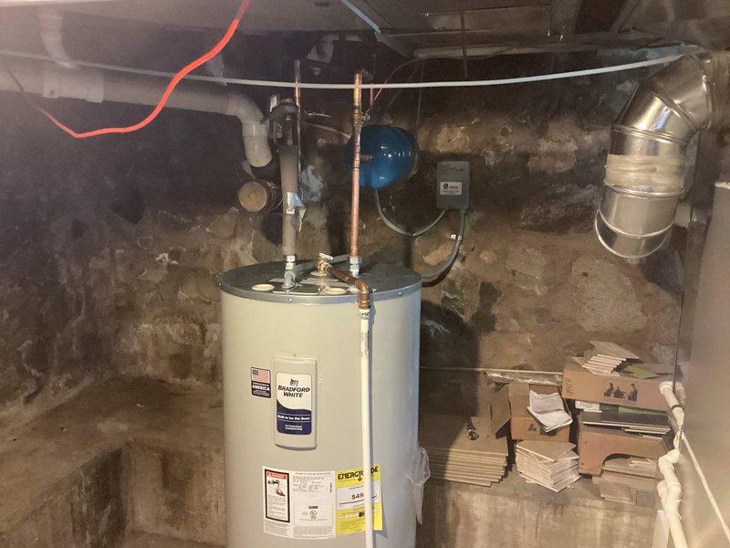 Installed a 50-gallon Bradford White electric water heater in basement utility area. Connected all necessary copper supply lines, PVC discharge piping, pressure relief valve, and electrical wiring to existing circuits. Verified proper operation of expansion tank and all safety components upon system startup.