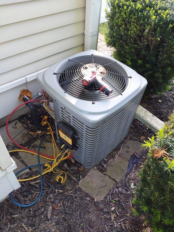 Completed routine air conditioning maintenance on residential condenser unit. Connected manifold gauges and verified refrigerant pressures and system performance. Inspected electrical connections, condenser coil condition, and fan operation. Unit operating within normal parameters upon completion of maintenance service.