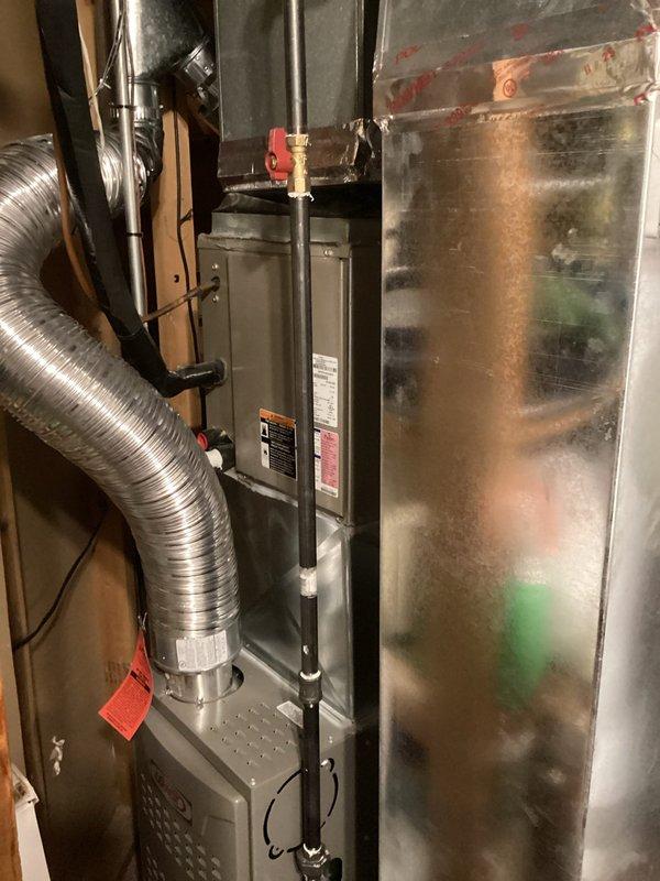 Conducted replacement estimate for existing R-22 air conditioning system previously flagged for replacement. Assessed current air handler unit showing significant age-related deterioration including surface discoloration, condensation staining, and accumulated dirt buildup on metal plenum. Documented existing equipment configuration including copper refrigerant lines, flexible ductwork connections, and control panel mounting. Photographed installation area in basement mechanical room to provide comprehensive system evaluation for replacement proposal. Coordinated arrival time with occupant prior to scheduled appointment window.