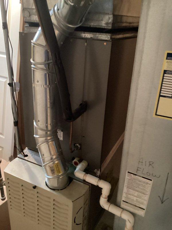 Conducted on-site evaluation for central air conditioning system replacement in residential property. Assessed existing HVAC infrastructure including Bryant furnace, water heater, and current mechanical room configuration with PVC condensate drainage and metal ductwork. Documented equipment layout, available installation space, and existing utility connections. Photographed current system components and mechanical room setup to prepare comprehensive replacement estimate for new central AC unit compatible with existing furnace and ductwork configuration.