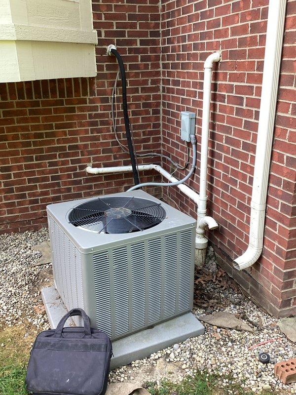Completed estimate for air conditioning system replacement. Existing outdoor condenser unit evaluated due to age and low refrigerant levels, indicating system has reached end of serviceable life. Assessed current installation including condenser positioned on concrete pad with gravel surround, refrigerant lines, electrical disconnect, and PVC condensate drainage system. Reviewed electrical service panel for compatibility with replacement equipment requirements. Provided two quote options for system replacement to address cooling system failure.