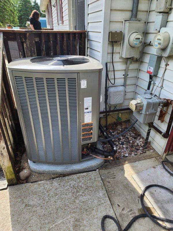 Completed full HVAC system installation including Lennox furnace, air conditioner, humidifier, and S40 thermostat per takeoff specifications. Outdoor condensing unit installed on concrete pad with proper electrical connections to exterior meter panel, and indoor air handler positioned in basement utility area with PVC condensate drainage and venting configured. All equipment operational and financing documentation finalized.
