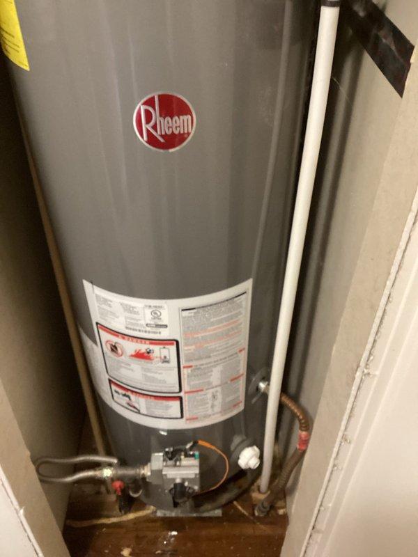 Performed on-site evaluation and estimate for replacement of 20-year-old Rheem residential water heater installed in utility closet. Documented existing unit condition, plumbing connections including gas control valve assembly, inlet/outlet configurations, and clearance constraints within confined installation space. Photographed current equipment specifications and existing piping arrangements to provide accurate replacement quote.