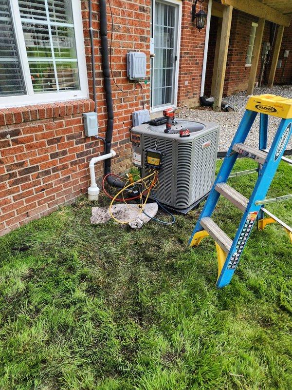 Completed installation of new Lennox air conditioning system at residential property. Installed outdoor condenser unit on concrete pad with proper electrical disconnect, ran refrigerant lines and electrical conduit along exterior brick wall, connected to existing Coleman furnace indoor air handler in basement, charged system with refrigerant, performed startup procedures, and verified proper operation of complete cooling system.