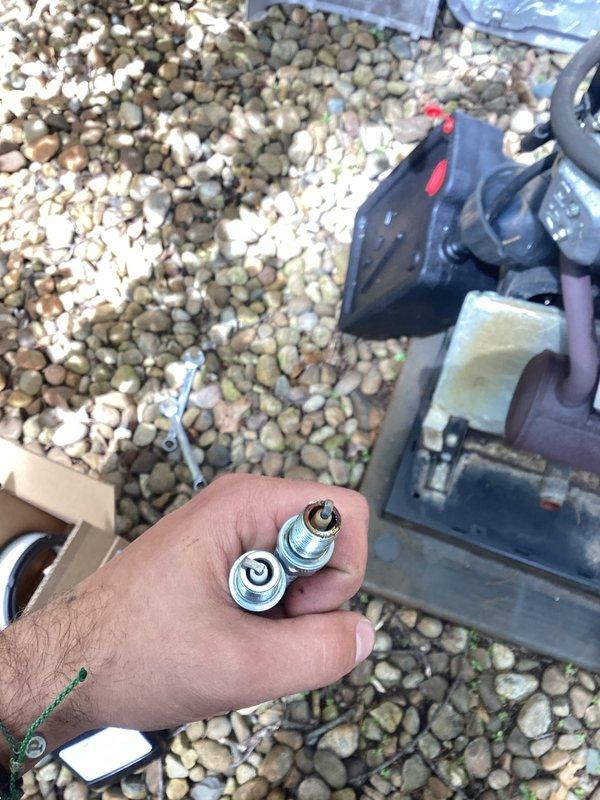 Completed routine generator maintenance inspection and service. Performed visual inspection of outdoor generator unit, noting weathered condition with surface oxidation on housing and lid. Verified unit accessibility and cleared vegetation growth around base perimeter. Conducted standard preventive maintenance procedures including mechanical assessment and component verification using appropriate hand tools and socket attachments. Unit operational following maintenance completion.
