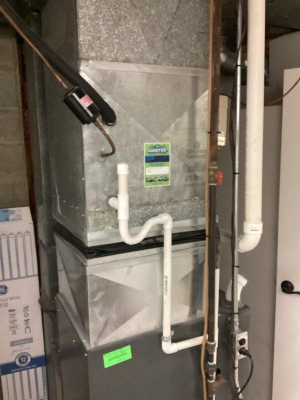 Completed estimate for replacement of 20-year-old non-operational air conditioning system located in basement utility room. Assessed existing furnace/air handler configuration with current ductwork, refrigerant lines, and condensate drainage system. Documented equipment specifications and installation requirements including flexible duct connections and structural considerations for new system installation.