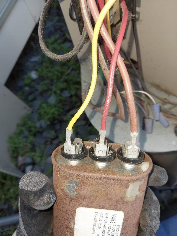 Responded to no cooling complaint on 18-year-old air conditioning system. Upon inspection, found outdoor condenser unit with severely rusted dual run capacitor showing advanced corrosion from prolonged moisture exposure. Capacitor failure prevented compressor and condenser fan motor operation, resulting in complete loss of cooling capability. Replaced failed capacitor with new component rated to manufacturer specifications. Tested system operation and confirmed compressor startup, proper fan motor function, and cooling cycle initiation. Given the age of the equipment and extent of component deterioration observed, advised customer that additional failures are likely and recommended considering system replacement to avoid ongoing repair costs.