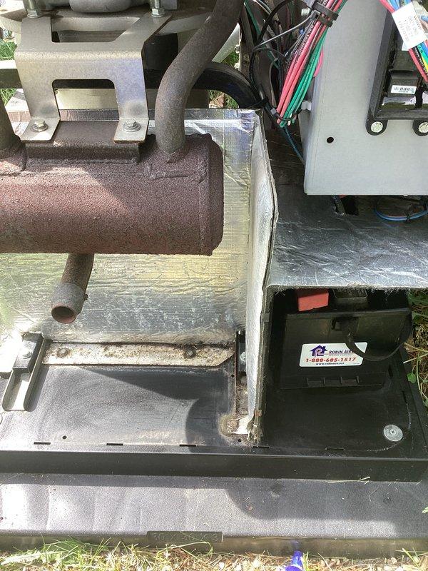 Performed routine maintenance on residential standby generator unit. Removed, inspected, and replaced spark plugs showing normal wear patterns. Verified all electrical connections, wiring harnesses, and control box components for proper operation and secure mounting. Unit tested successfully following maintenance completion.