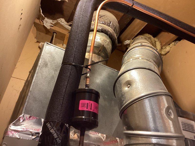 Completed installation of new Bryant air conditioning system including outdoor condensing unit, electrical disconnect box with proper labeling, and interior ductwork modifications. Installed flexible ductwork, inline filter assembly, and metal supply ducts with fiberglass insulation at joints to ensure proper airflow distribution throughout the residence. All electrical connections, conduit runs, and HVAC components were secured per manufacturer specifications and local building codes, with financing documentation processed and pending final execution.