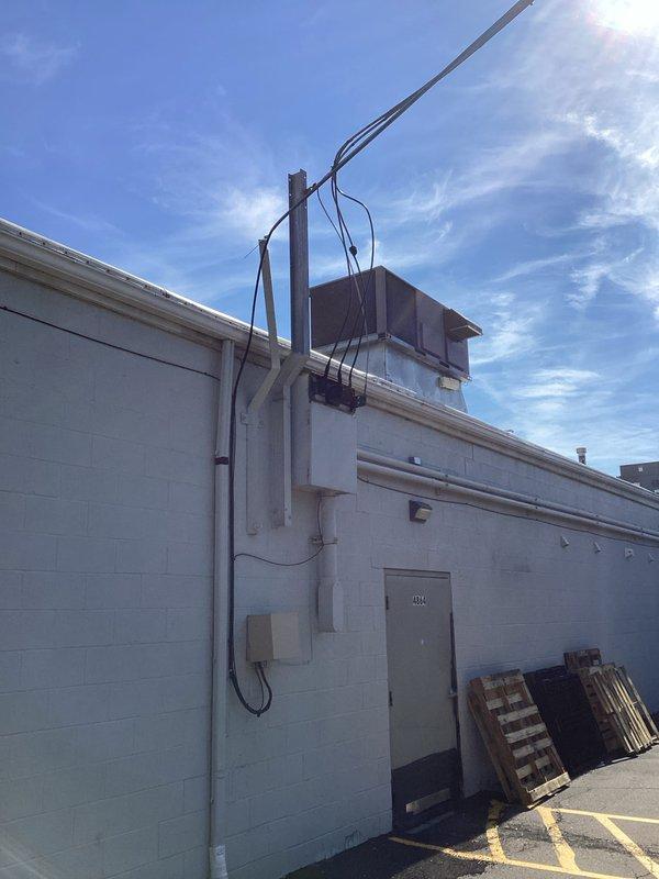 Conducted commercial rooftop unit replacement estimate for building #2334. Assessed existing RTU system that was previously evaluated by another contractor who recommended replacement over repair due to cost considerations. Documented current rooftop unit condition, mounting configuration on roof curb, associated electrical service panel, and conduit routing on exterior wall. Provided comprehensive replacement proposal for commercial-grade HVAC equipment.