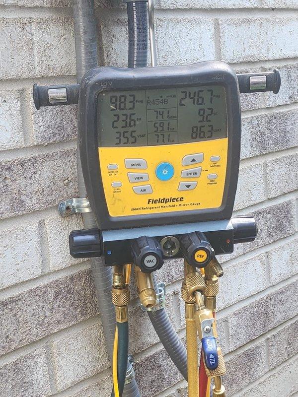 Responded to service call for newly installed air conditioning system struggling to maintain temperature during peak afternoon hours. Connected Fieldpiece SMAN refrigerant manifold and micron gauge to evaluate system performance and refrigerant charge. Measured operating pressures, temperatures, and superheat/subcooling values on R454B refrigerant system. Initial readings indicated system parameters were within acceptable range. Monitored compressor operation and verified proper airflow across evaporator and condenser coils. System appeared to be operating as designed with no immediate refrigerant leaks or mechanical deficiencies detected. Advised that newly installed equipment may require brief break-in period and continued monitoring during extreme heat conditions to establish baseline performance.