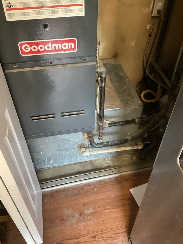 Provided estimate for complete HVAC system replacement at residential property with 20-year-old equipment currently experiencing no cooling condition. Evaluated existing outdoor condensing unit located in backyard with vegetation growth around base and indoor furnace unit positioned in utility closet with natural gas fuel source. Documented equipment locations, electrical conduit routing on exterior wall, and existing gas line connections to prepare comprehensive replacement proposal for new system installation.