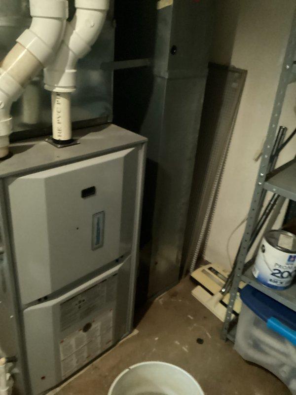 Completed full system replacement estimate for residential HVAC equipment following diagnosis of R22 refrigerant deficiency in existing air conditioning system. Assessed current furnace and air handler installation in basement mechanical room, documenting existing white gas furnace with PVC venting, galvanized ductwork, and aging air conditioning components with copper refrigerant lines. Provided comprehensive replacement options for complete heating and cooling system upgrade due to obsolete R22 refrigerant system and equipment age considerations.