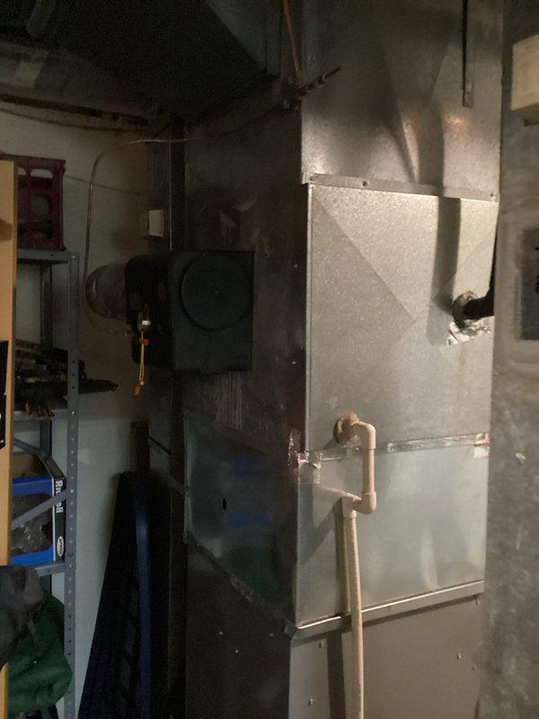 Completed full system replacement estimate for residential HVAC equipment following diagnosis of R22 refrigerant deficiency in existing air conditioning system. Assessed current furnace and air handler installation in basement mechanical room, documenting existing white gas furnace with PVC venting, galvanized ductwork, and aging air conditioning components with copper refrigerant lines. Provided comprehensive replacement options for complete heating and cooling system upgrade due to obsolete R22 refrigerant system and equipment age considerations.