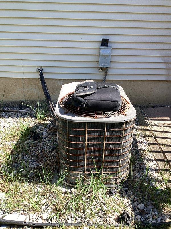 Completed comprehensive HVAC system replacement estimate for a residential split system installation. Assessment included evaluation of existing outdoor condenser unit with weathered components and indoor air handler with associated ductwork, condensate drainage system, and electrical connections. Documented current system configuration including refrigerant line routing, electrical disconnect placement, and equipment positioning for replacement specifications.