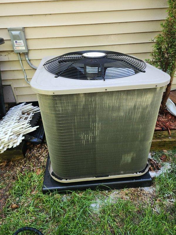 Completed comprehensive cooling system maintenance and tune-up on residential air conditioning unit. Performed standard preventive maintenance procedures including inspection of outdoor condenser unit with green side panels, verified proper operation of all components, and conducted drain system testing using inflatable bladder method in condensate pan. System tested and confirmed operational with all refrigerant lines, electrical connections, and coil assemblies functioning within normal parameters.