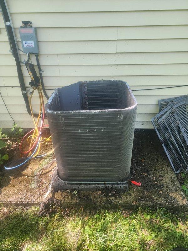 Responded to no cooling complaint on residential air conditioning system. Upon inspection, found compressor failed to operate properly. Removed top grille to access internal components and diagnosed compressor failure. Replaced defective compressor and associated copper refrigerant lines. Reinstalled unit housing and tested system operation. Unit now cooling properly and operating within manufacturer specifications. All work completed under existing labor and parts warranty coverage.
