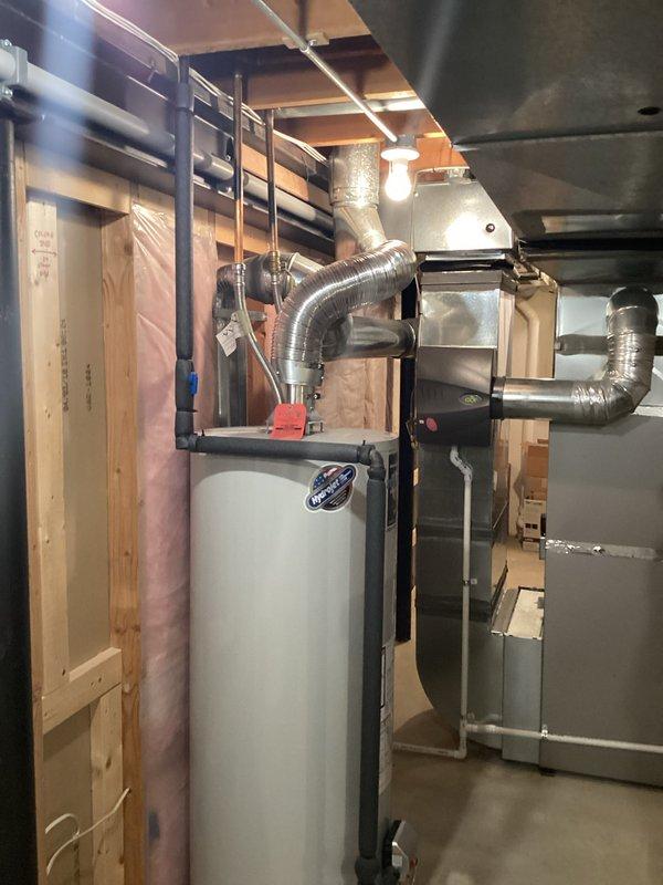 Provided estimate for replacement of existing water heater manufactured in 1996. Unit is approaching end of service life at 28-29 years old and may fail within 3-5 years based on typical lifespan expectations. Documented current installation including connections, venting, and placement in basement mechanical room adjacent to HVAC equipment for replacement planning purposes.