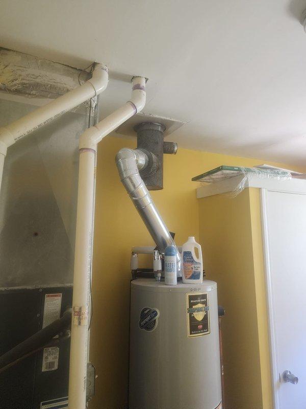 Responded to service call for displaced chimney cap and chimney liner condition assessment. Performed visual inspection of chimney penetration at roof level, documenting significant weathering and mineral efflorescence around the flue opening indicating moisture infiltration. Inspected water heater venting system and flue connection in mechanical room to verify proper draft and clearances. Provided customer with photographic documentation of chimney condition and recommendations for cap replacement and further liner evaluation.