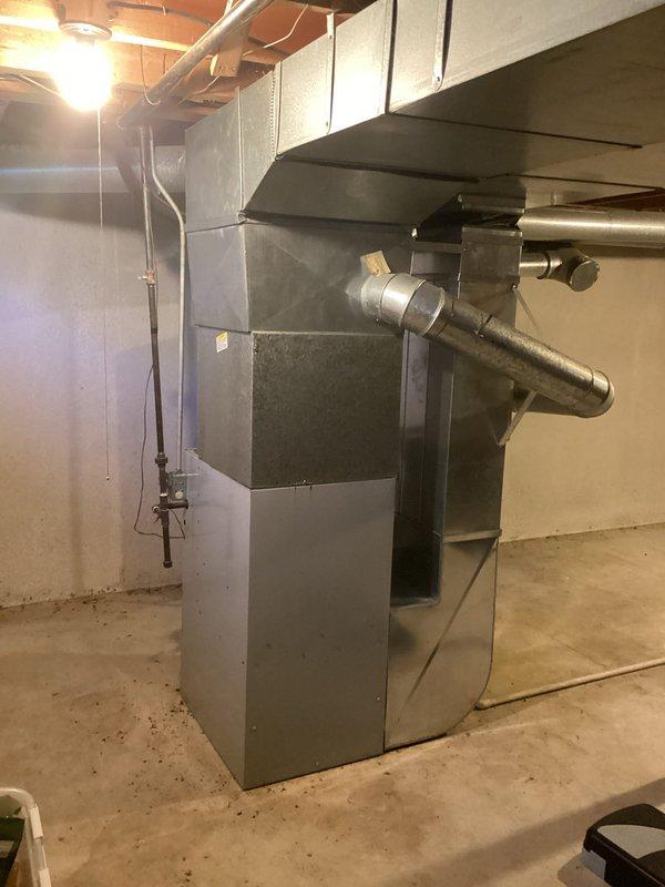 Conducted on-site assessment of residential HVAC system in basement mechanical room and identified cracked heat exchanger requiring full furnace replacement. Prepared comprehensive replacement estimate quotes for gray sheet metal furnace unit with existing ductwork configuration, documenting current system layout including rectangular air handler, metallic supply/return ductwork, and basement installation specifications. Photographed existing equipment and mechanical room conditions to support replacement recommendations and ensure accurate sizing for new system installation.