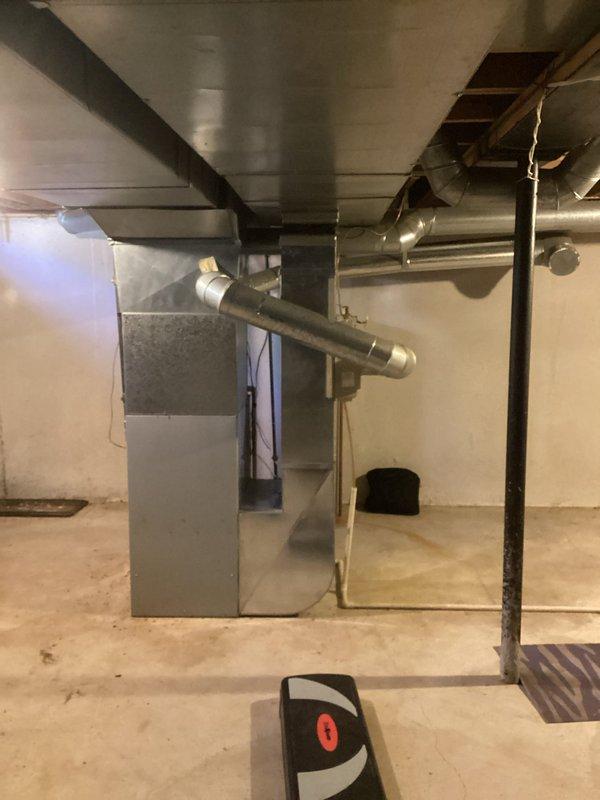 Conducted on-site assessment of residential HVAC system in basement mechanical room and identified cracked heat exchanger requiring full furnace replacement. Prepared comprehensive replacement estimate quotes for gray sheet metal furnace unit with existing ductwork configuration, documenting current system layout including rectangular air handler, metallic supply/return ductwork, and basement installation specifications. Photographed existing equipment and mechanical room conditions to support replacement recommendations and ensure accurate sizing for new system installation.