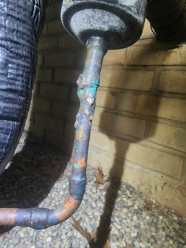 Responded to callback for new AC unit experiencing short cycling issues. Upon arrival, performed diagnostic testing using digital manifold gauges to assess system pressures and operation. Measured refrigerant pressures and temperatures, which revealed abnormal readings indicating potential system imbalance. 

During inspection, discovered severe corrosion and oxidation on exterior refrigerant line with visible blue-green patina, rust spots, and flaking coating, suggesting extended moisture exposure that may be contributing to system performance issues. Documented deteriorated copper line condition and monitored system operation to identify short cycling pattern. Further evaluation recommended to address refrigerant line corrosion and verify proper system charge and operation.