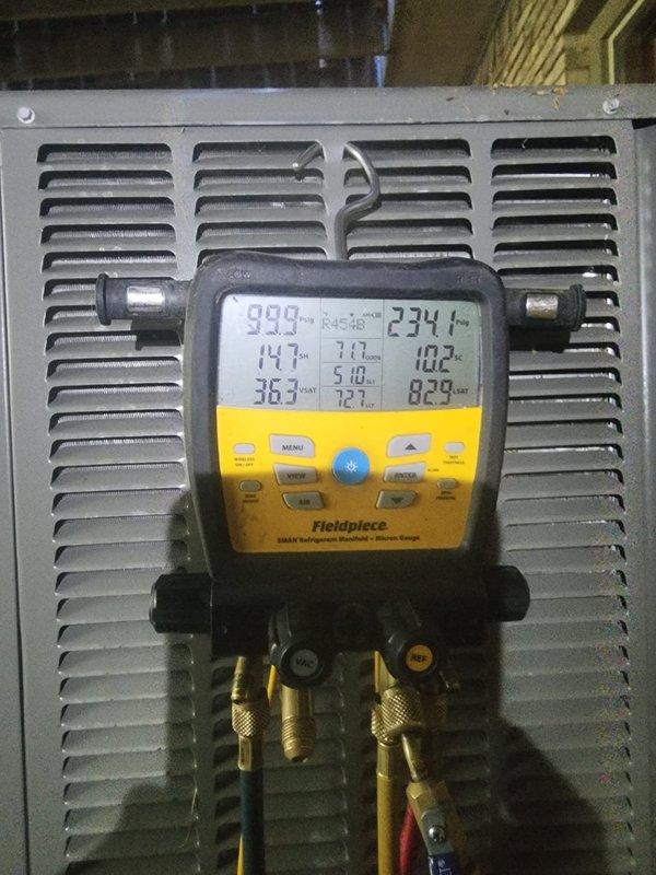 Responded to callback for new AC unit experiencing short cycling issues. Upon arrival, performed diagnostic testing using digital manifold gauges to assess system pressures and operation. Measured refrigerant pressures and temperatures, which revealed abnormal readings indicating potential system imbalance. 

During inspection, discovered severe corrosion and oxidation on exterior refrigerant line with visible blue-green patina, rust spots, and flaking coating, suggesting extended moisture exposure that may be contributing to system performance issues. Documented deteriorated copper line condition and monitored system operation to identify short cycling pattern. Further evaluation recommended to address refrigerant line corrosion and verify proper system charge and operation.
