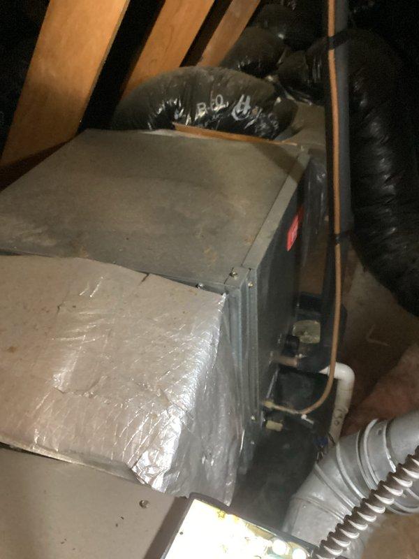 Provided estimate for complete air conditioning system replacement in attic-mounted installation. Existing gray metal air handler and associated ductwork assessed as non-operational and aged beyond serviceable life. Documented current system configuration including flexible ductwork, copper refrigerant lines, and PVC condensate drainage for replacement specifications.