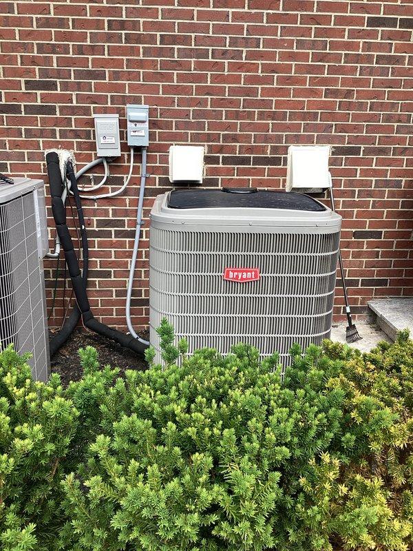 Completed full HVAC system replacement including Bryant brand air conditioning condenser unit and indoor air handler/furnace. Removed existing system that had experienced repeated failures and installed new equipment on existing concrete pad against exterior brick wall. Connected refrigerant lines, electrical disconnects, and PVC condensate drainage. Installed Resideo monitoring device on indoor unit for system diagnostics. Verified all electrical connections, tested system operation, and confirmed proper airflow through existing ductwork.