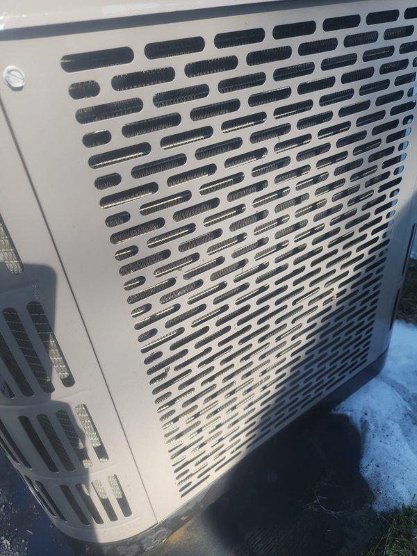 Responded to service call for air conditioning system not maintaining set temperature at trailer residence. Upon arrival, performed visual inspection of 4-year-old outdoor condensing unit. Examined exterior cabinet panels, verified proper ventilation through grille openings, and noted unit placement on concrete pad. Removed top access panel to inspect internal components including compressor, condenser coil, and refrigerant lines. Condenser coil fins appeared clean with no visible blockage or damage. Compressor and copper refrigerant lines showed no signs of leakage, corrosion, or unusual wear. System demonstrated partial cooling capacity but insufficient to reach thermostat setpoint. Documented unit condition with photographs for service records.