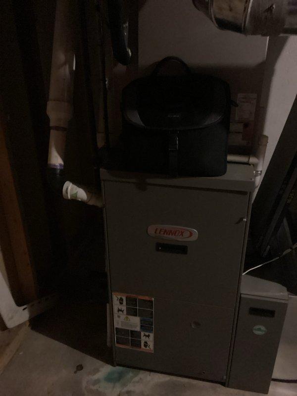 Conducted on-site assessment of existing Lennox furnace system located in basement utility area for complete HVAC replacement estimate. Documented current equipment condition, specifications, and installation configuration including connected copper refrigerant lines and plumbing connections. Photographed unit identification plates and surrounding mechanical room layout to provide accurate equipment sizing and replacement system recommendations.