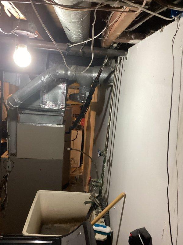 Conducted comprehensive on-site assessment of existing residential HVAC system in basement mechanical room to provide replacement estimate. Evaluated current furnace/air handler configuration, ductwork layout including horizontal trunk lines and branch connections, and overall system accessibility for equipment changeout. Documented existing equipment specifications, duct connections, clearances, and spatial constraints through photographic survey to determine optimal replacement equipment sizing and installation requirements.