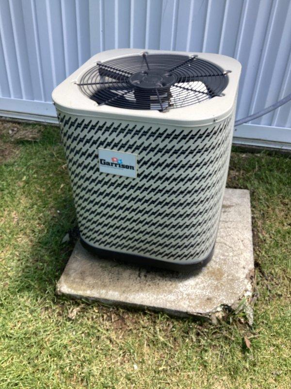 Conducted comprehensive site evaluation for complete air conditioning system replacement. Assessed existing Garrison brand outdoor condenser unit with diamond-pattern grille and indoor air handler equipment installed in interior closet space. Documented current equipment conditions, measurements, and installation requirements. Provided detailed replacement estimate for new HVAC system including removal of existing components and installation specifications for updated equipment.