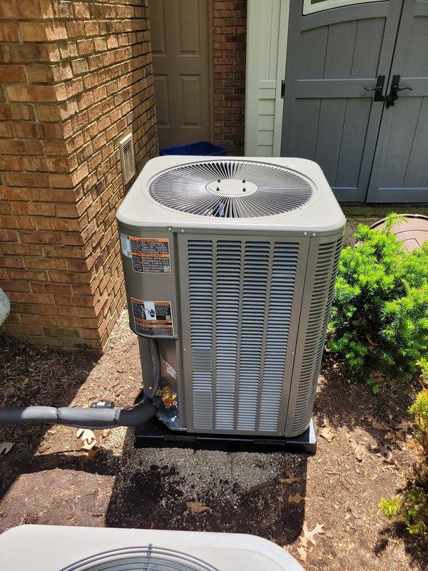 Completed installation of new Lennox air conditioning system at residential property. Unit was positioned on concrete pad adjacent to brick exterior, with refrigerant lines routed along wall to interior air handler, electrical disconnect box mounted per code requirements, and system tested for proper operation upon completion.