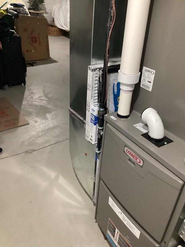 Completed estimate for replacement of 10-year-old air conditioning system that was found to be low on refrigerant. Assessed existing Lennox furnace and air handler installation in basement mechanical room, documented current system configuration including ductwork, PVC venting, and copper refrigerant lines. Provided homeowner with replacement options and recommendations based on age of equipment and refrigerant loss issue.