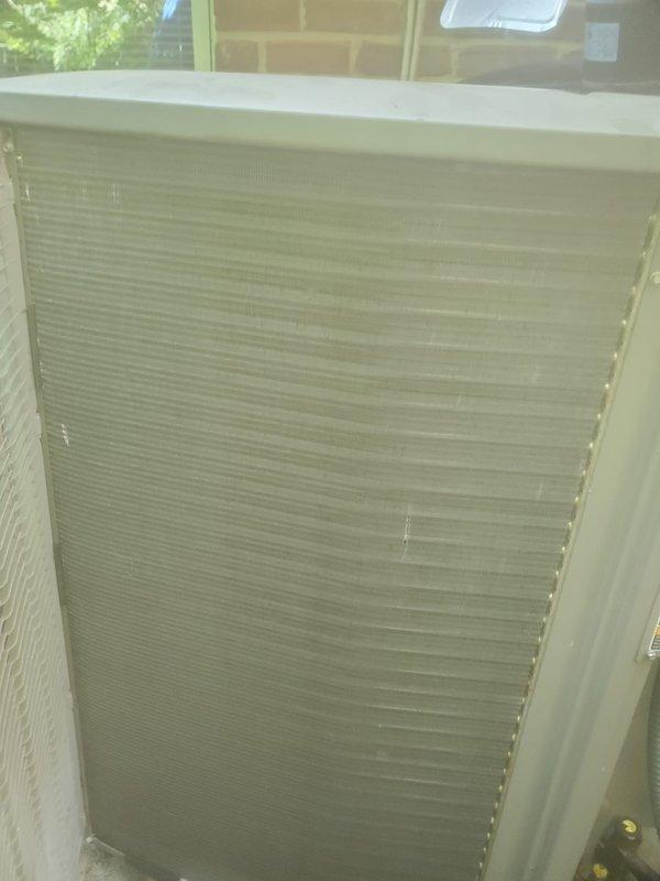 Completed comprehensive cooling system maintenance and tune-up on outdoor air conditioning condenser unit. Performed full system inspection, cleaned condenser coils and louvers, checked refrigerant levels and pressures, tested electrical connections and capacitors, verified proper airflow through intake grilles, and confirmed optimal system operation. Unit is functioning properly with no issues identified.