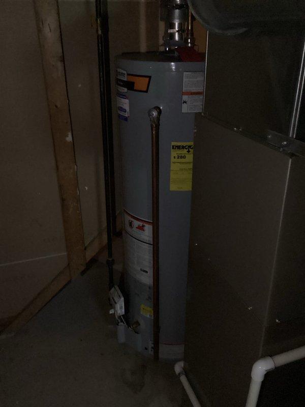 Conducted on-site water heater evaluation in residential basement utility space. Assessed existing cylindrical tank-style water heater installation, documented current equipment specifications, venting configuration with flexible aluminum ductwork, and associated plumbing connections including supply and discharge lines. Provided comprehensive estimate for water heater replacement options based on current system layout and mechanical room conditions.
