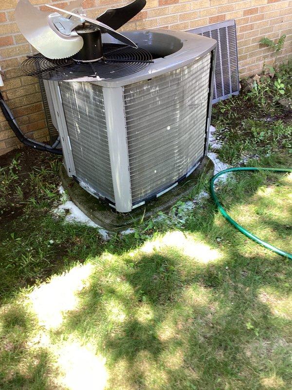 Completed preventive maintenance inspection on residential single-phase air conditioning system. Performed visual inspection of outdoor condenser unit, confirming proper clearances and secure mounting on concrete pad. Inspected interior components including evaporator coil, compressor assembly, drain pan, and electrical connections. Noted minor surface rust and mineral deposits in base pan consistent with normal condensate drainage over time. All refrigerant lines, electrical wiring, and mechanical components found secure with no immediate service needs identified. Unit operational and ready for cooling season.